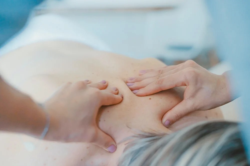 Massage therapist performing therapeutic back massage at New Beginnings in Wyomissing, PA